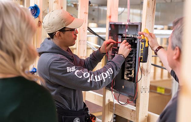Student Working with Construction Electrician Equipment at Anoka Technical College.