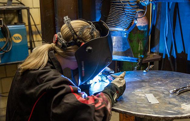 A Welding Student Working on a Project. 